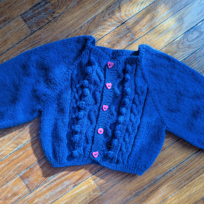 Top-down knitting construction of Twist and Shout child’s cardigan